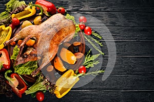 Baked turkey with vegetables and spices. l. On a wooden background. Top view