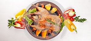 Baked turkey with vegetables and spices. Thanksgiving day. Goose chicken grill. On a wooden background.