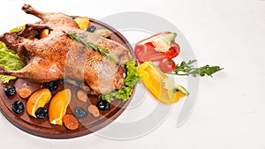 Baked turkey with vegetables and spices. Thanksgiving day. Goose chicken grill. On a wooden background.