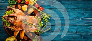 Baked turkey with vegetables and spices. Thanksgiving day. Goose chicken grill. On a wooden background.