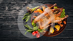 Baked turkey with vegetables and spices. Thanksgiving day. Goose chicken grill. On a wooden background.