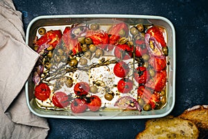 Baked vegetables with feta cheese, olives, onions, Provencal herbs, spices, olive oil and tomatoes. Home cooking concept