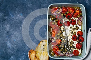 Baked vegetables with feta cheese, olives, onions, Provencal herbs, spices, olive oil and tomatoes. Home cooking concept