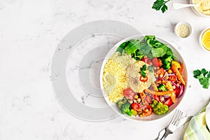 Baked vegetables with hummus bowl. Salad with baked potato, zucchini, broccoli and hummus.