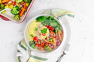 Baked vegetables with hummus bowl. Salad with baked potato, zucchini, broccoli and hummus.