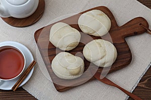 baked white bread tea cup on wood cutting board isolated on table