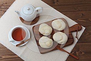 baked white bread tea cup on wood cutting board isolated on table