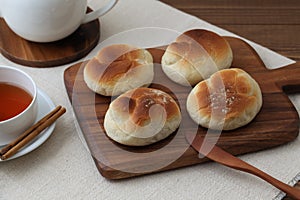 baked white bread on wood cutting board isolated on table