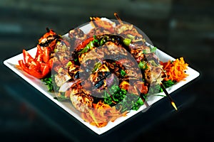 Baked whole chicken with oranges and potatoes on a plate. horizontal view from above