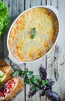 Baked zucchini and cheese soufle with italian bruschetta and herbs
