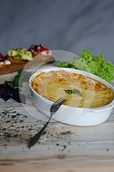 Baked zucchini and cheese soufle with italian bruschetta and herbs