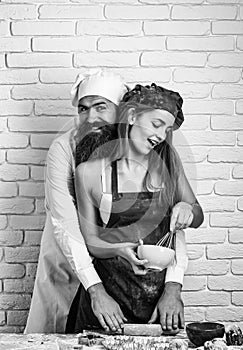 Baker cooking cakes with girl