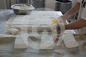 Baker Cutting Raw Ciabatta Bread Dough