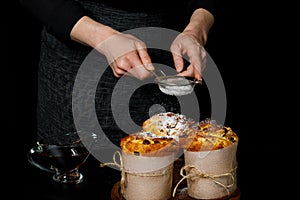 A baker decorates kraffins with powdered sugar photo