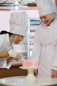 Baker decorating cake