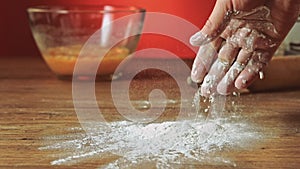 Baker hand throwing flour on the table, slow motion, 240 fps. Cooking and backing preparation. Food preparation on the