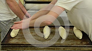 Baker hands kneading bread dough in bakery. Making bread. Men manually kneading fresh dough. Workers preparing pastry dough in bak