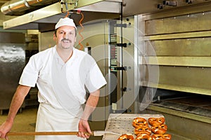 Baker in his bakery baking bread