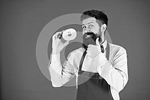 Baker hold donut. Funny hipster. Sweet donut. Chef man in cafe. Diet and healthy food. Doughnut diet. Calorie. Feel