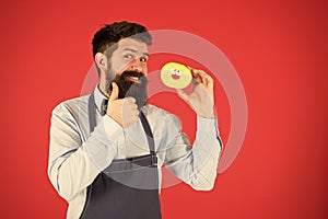 Baker hold donut. Funny hipster. Sweet donut. Chef man in cafe. Diet and healthy food. Doughnut diet. Calorie. Feel