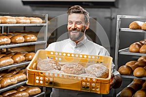 Baker holding breads at the manufacturing
