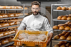 Baker holding breads at the manufacturing photo