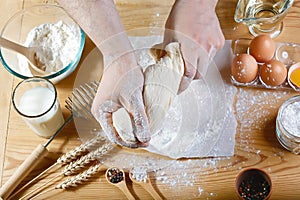 Baker knead dough bread, pizza or pie recipe ingredients with hands, food on kitchen table background, working with milk, yeast, f