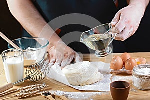 Baker knead dough bread, pizza or pie recipe ingredients with hands, food on kitchen table background, working with milk, yeast, f