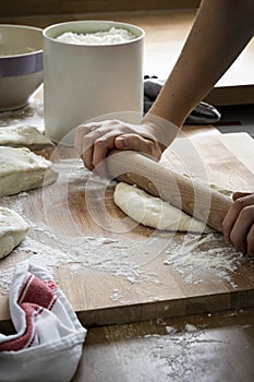 Baker kneading a dough in kitchen closeup