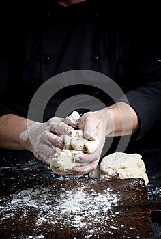 Baker kneads white wheat flour dough