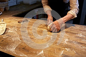 Baker making bread dough at bakery kitchen