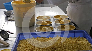 Baker making pie cases in industrial bakery