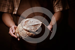 Baker man holding a round bread
