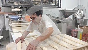 Baker working in industrial bakery photo