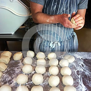 Baker prepares bread rolls