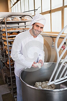 Baker preparing dough in industrial mixer