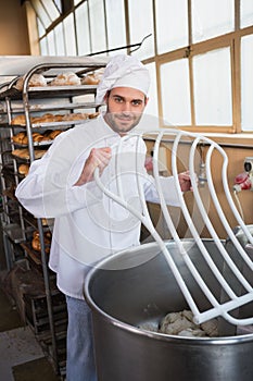 Baker preparing dough in industrial mixer