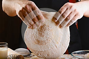 Baker rolling dough with flour bread, pizza or pie recipe ingredients with hands, food on kitchen table background, working with m