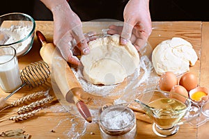 Baker rolling dough with flour bread, pizza or pie recipe ingredients with hands, food on kitchen table background, working with m