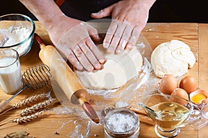 Baker rolling dough with flour bread, pizza or pie recipe ingredients with hands, food on kitchen table background, working with m