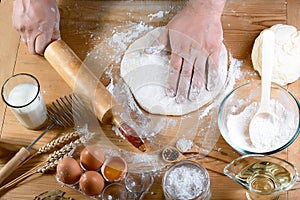 Baker rolling dough with flour bread, pizza or pie recipe ingredients with hands, food on kitchen table background, working with m