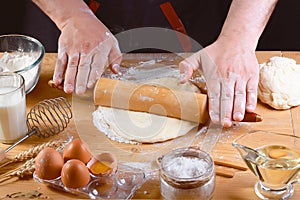 Baker rolling dough with flour bread, pizza or pie recipe ingredients with hands, food on kitchen table background, working with m