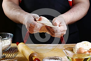 Baker rolling dough with flour bread, pizza or pie recipe ingredients with hands, food on kitchen table background, working with m