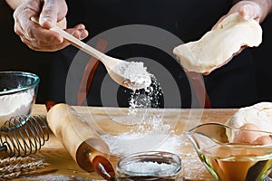 Baker rolling dough with flour bread, pizza or pie recipe ingredients with hands, food on kitchen table background, working with m