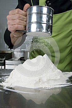 Baker sieving flour