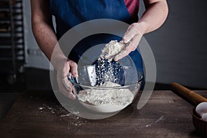 Baker sifting flour