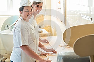 Baker women working in bakehouse of bakery