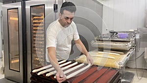 Baker working in industrial bakery photo