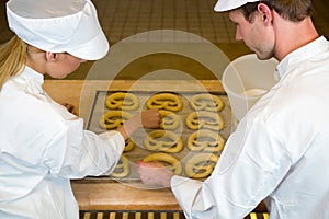 Bakers in bakery producing pretzels