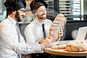 Bakers working with bread in the office